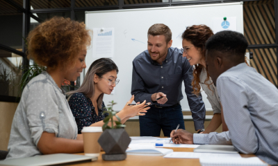 A small business owner engages with his employees